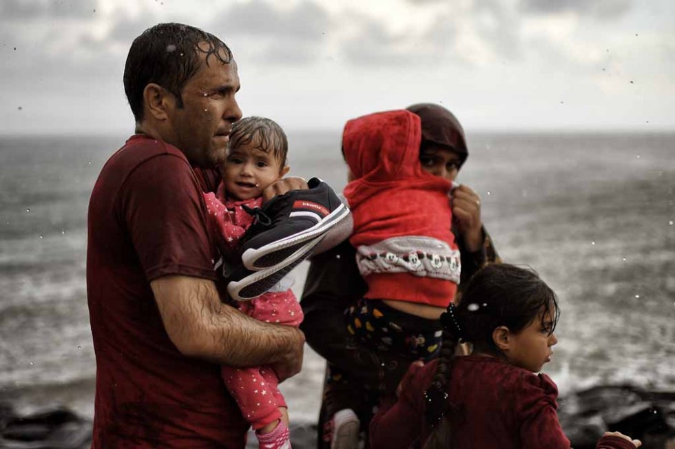A soaked family arrives on the shores of Lesbos in late September. A soaked family arrives on the shores of Lesbos in late September.