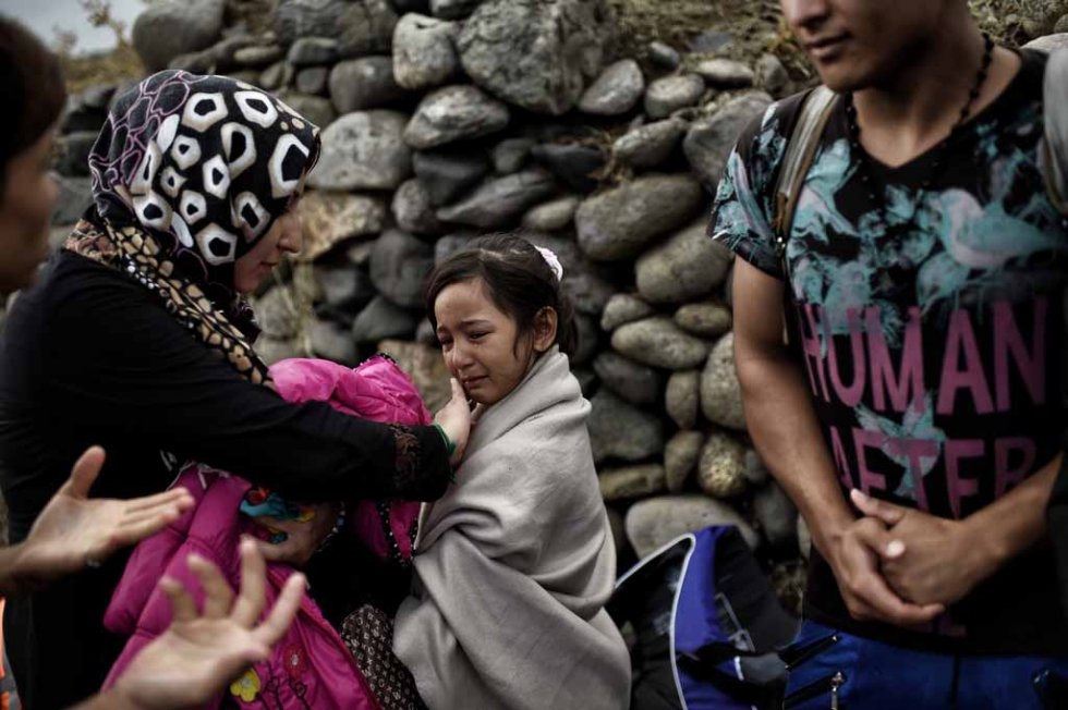 An Afghan girl is comforted after arriving on Lesbos in late September. An Afghan girl is comforted after arriving on Lesbos in late September.