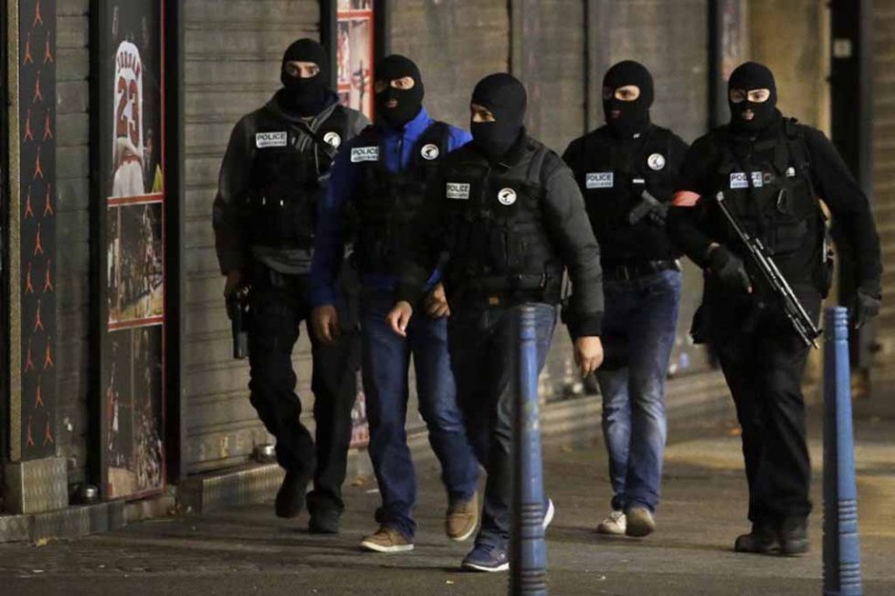 Masked French policemen in the Paris suburb of Saint-Denis as security forces raided an apartment in an operation targeting the mastermind of the attacks. (AFP/Kenzo Tribouillard) Masked French policemen in the Paris suburb of Saint-Denis as security forces raided an apartment in an operation targeting the mastermind of the attacks. (AFP/Kenzo Tribouillard)