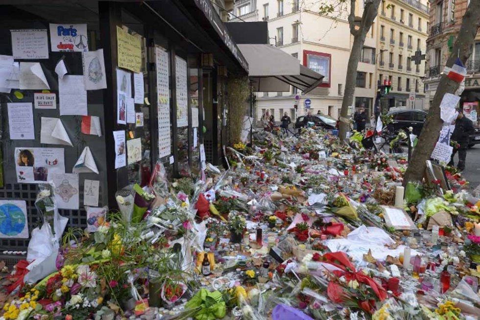 Flowers pile up on the sidewalk outside of the Belle Equipe restaurant. Flowers pile up on the sidewalk outside of the Belle Equipe restaurant.