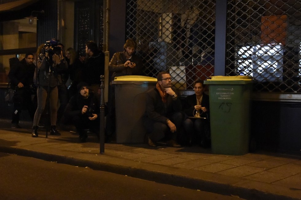 Journalists take cover near the Bataclan concert hall. Journalists take cover near the Bataclan concert hall.