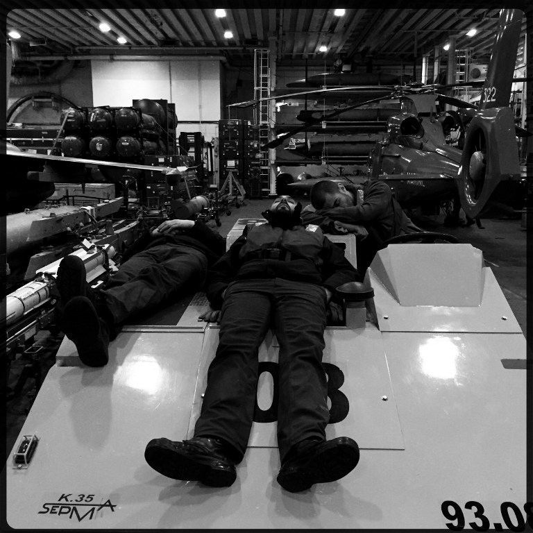 Rafale fighter jet technicians take a nap in the hangar of the Charles de Gaulle on February 25, 2015 Rafale fighter jet technicians take a nap in the hangar of the Charles de Gaulle on February 25, 2015