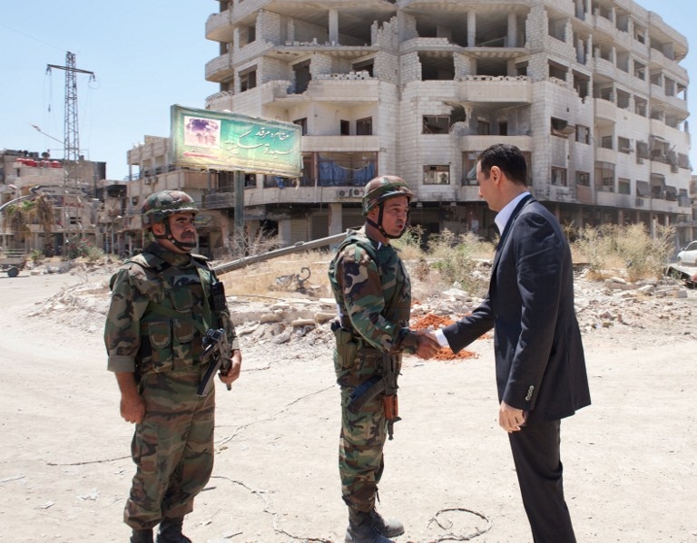 The strange look of the billboard in the background of this image issued by the official Syrian news agency SANA in August 2013, showing President Bashar al-Assad making a visit southwest of Damascus, led AFP to analyse it for possible manipulation. Verdi The strange look of the billboard in the background of this image issued by the official Syrian news agency SANA in August 2013, showing President Bashar al-Assad making a visit southwest of Damascus, led AFP to analyse it for possible manipulation. Verdi