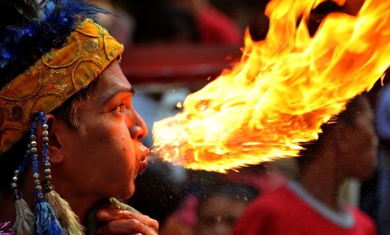 A fire breather performs in Chinatown in Manila a day before the Chinese New Year on January 22, 2012. The shape of the flame - coming just before the year of the dragon, led some observers to suspect manipulation. But after analysis the photo was proven A fire breather performs in Chinatown in Manila a day before the Chinese New Year on January 22, 2012. The shape of the flame - coming just before the year of the dragon, led some observers to suspect manipulation. But after analysis the photo was proven
