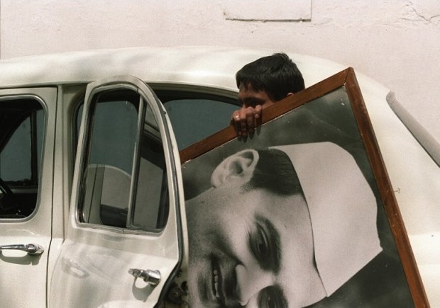 A youth removing a campaign poster of assassinated former Indian Prime Minister Rajiv Gandhi from his residence n Delhi on May 22, 1991 A youth removing a campaign poster of assassinated former Indian Prime Minister Rajiv Gandhi from his residence n Delhi on May 22, 1991