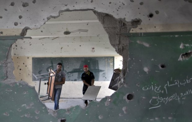 Workers carry tables in a classroom at a goverment school in Gaza City on September 13, 2014 one day before children go back to school Workers carry tables in a classroom at a goverment school in Gaza City on September 13, 2014 one day before children go back to school