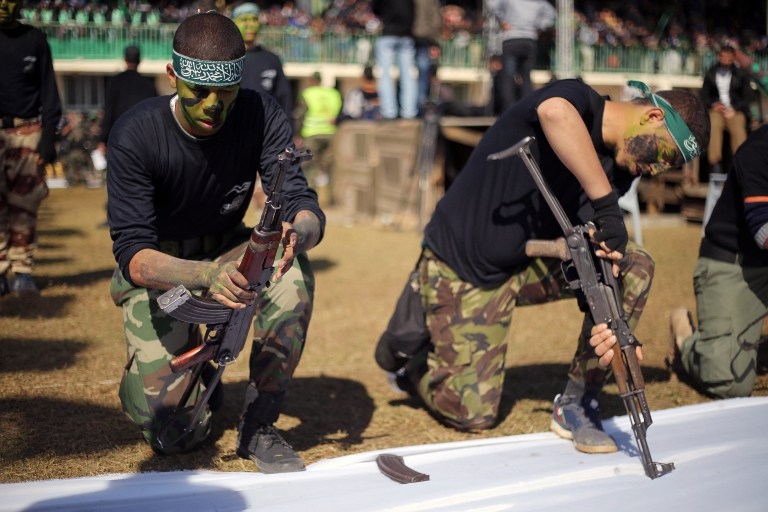 Youths show their weapons handling skills at a graduation ceremony for a Hamas-run training camp on January 29, 2015 in the southern Gaza Strip Youths show their weapons handling skills at a graduation ceremony for a Hamas-run training camp on January 29, 2015 in the southern Gaza Strip