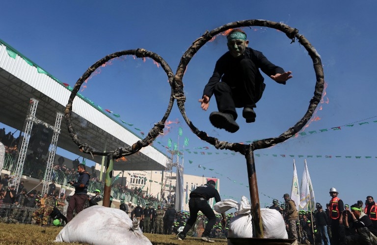 Youths jump through a ring of fire at a graduation ceremony for a Hamas-run training camp on January 29, 2015 in the southern Gaza Strip Youths jump through a ring of fire at a graduation ceremony for a Hamas-run training camp on January 29, 2015 in the southern Gaza Strip
