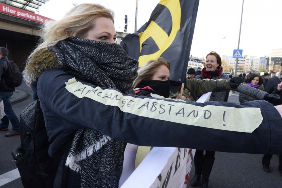 A far-right supporter sports a sticker reading 'at arm-length's distance,' in reference to a suggestion by Cologne's mayor on how women should behave to prevent being assaulted. January 9, 2016. A far-right supporter sports a sticker reading 'at arm-length's distance,' in reference to a suggestion by Cologne's mayor on how women should behave to prevent being assaulted. January 9, 2016.