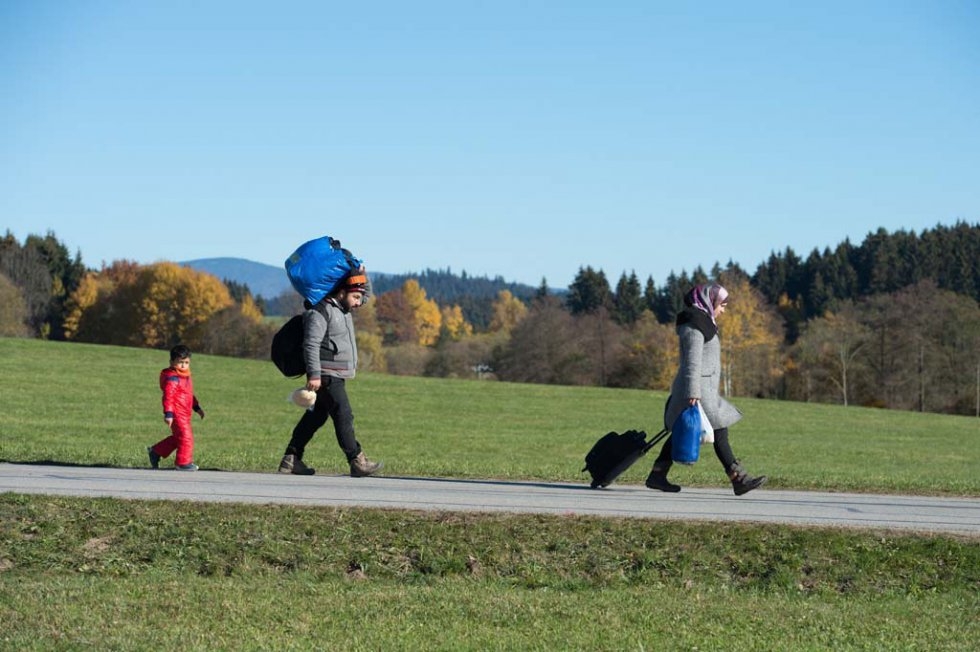 A refugee family walks to a registration centre after crossing into Germany from Austria. November, 2015. A refugee family walks to a registration centre after crossing into Germany from Austria. November, 2015.