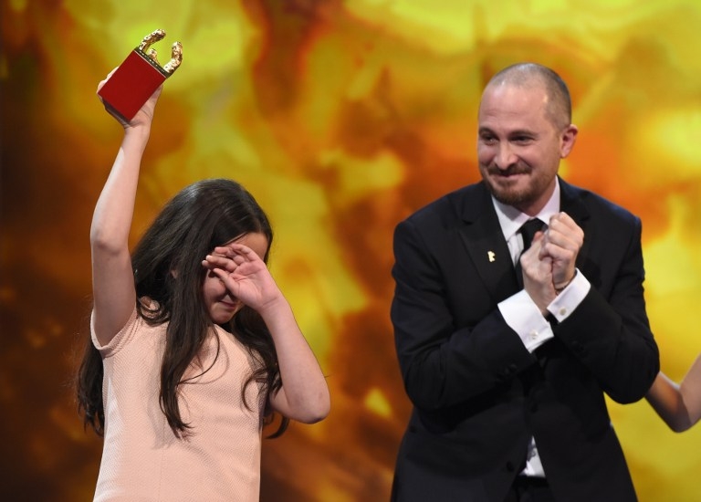 Jury head Darren Aronofsky looks on as Hana Saeidi accepts the Golden Bear best film trophy in place of her uncle, the Iranian director Jafar Panahi, at the Berlinale on February 14, 2015 Jury head Darren Aronofsky looks on as Hana Saeidi accepts the Golden Bear best film trophy in place of her uncle, the Iranian director Jafar Panahi, at the Berlinale on February 14, 2015
