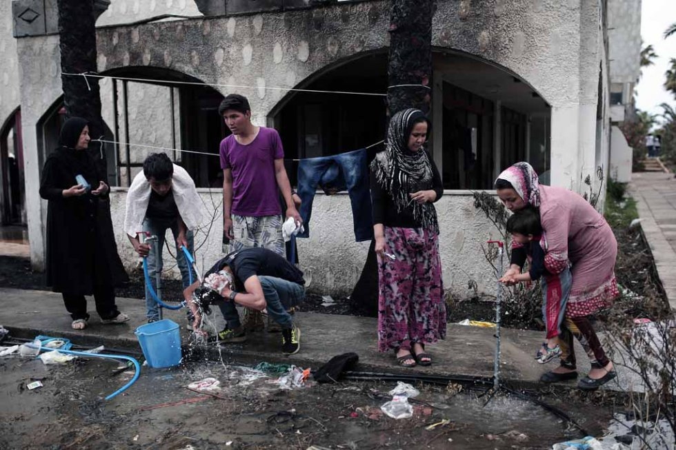 Migrants wash next to a deserted hotel in Kos. May, 2015. Migrants wash next to a deserted hotel in Kos. May, 2015.