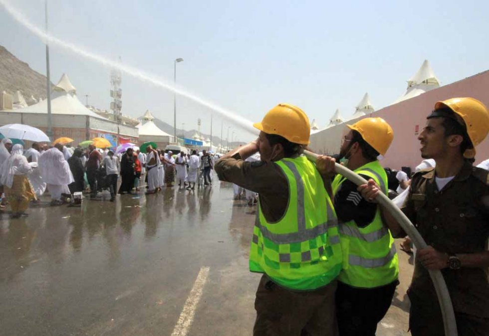 Saudi emergency personnel spray water to cool down the pilgrims in soaring temperatures. Saudi emergency personnel spray water to cool down the pilgrims in soaring temperatures.