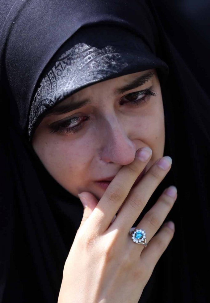 An Iranian woman mourns during a funeral procession for stampede victims. An Iranian woman mourns during a funeral procession for stampede victims.