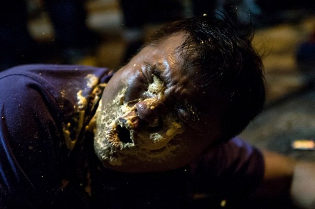 A local Hong Kong journalist collapses in agony after being hit in the face with pepper spray by police in the Mongkok district of Hong Kong on October 17, 2014 (AFP Photo / Alex Ogle) A local Hong Kong journalist collapses in agony after being hit in the face with pepper spray by police in the Mongkok district of Hong Kong on October 17, 2014 (AFP Photo / Alex Ogle)