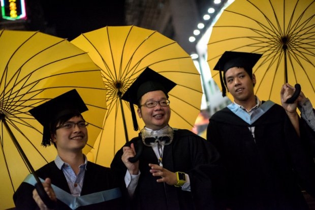College students carry umbrellas, symbols of Hong Kong's protest movement, on October 19, 2014 College students carry umbrellas, symbols of Hong Kong's protest movement, on October 19, 2014