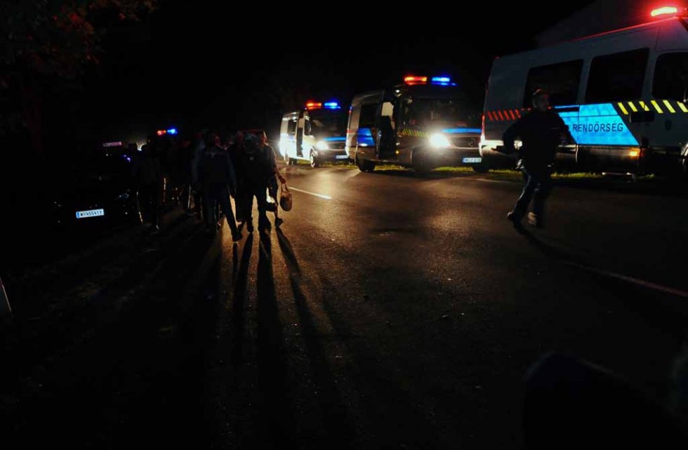 Migrants walk on a road near Rözske on September 8, 2015 Migrants walk on a road near Rözske on September 8, 2015