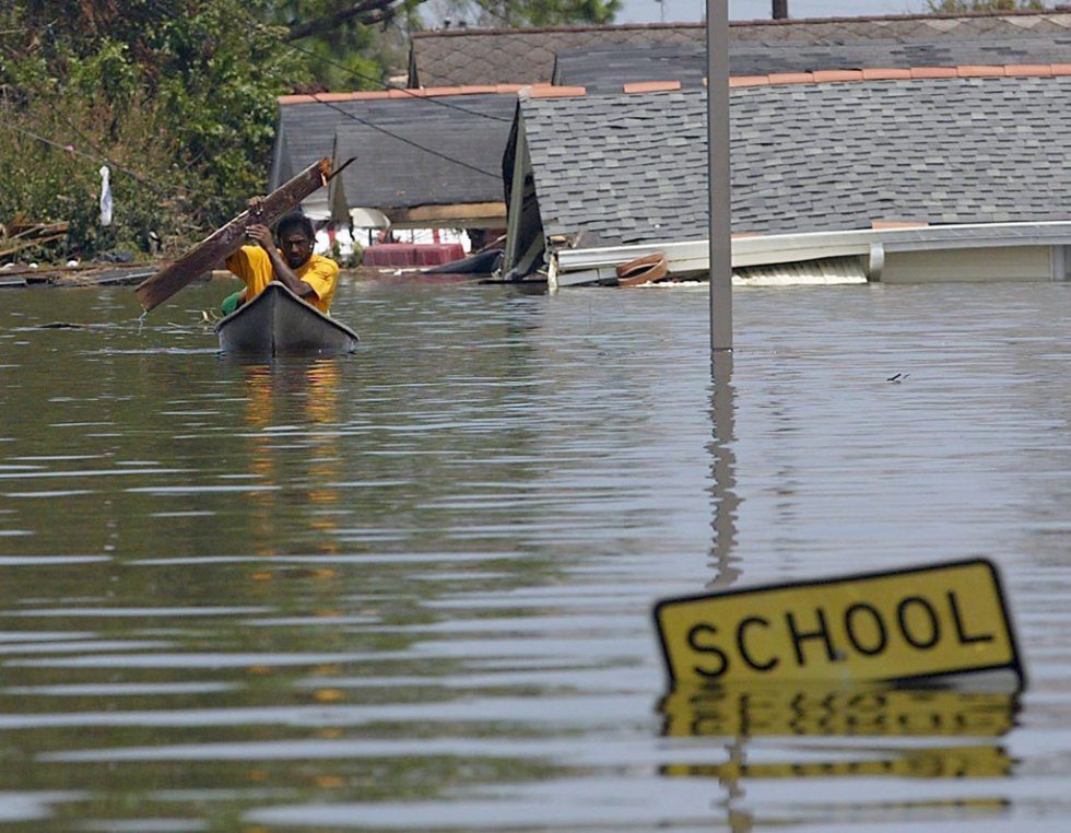 A resident uses a board to paddle through flood waters in New Orleans on August 30, 2005 following Hurricane Katrina (AFP Photo / James Nielsen) A resident uses a board to paddle through flood waters in New Orleans on August 30, 2005 following Hurricane Katrina (AFP Photo / James Nielsen)