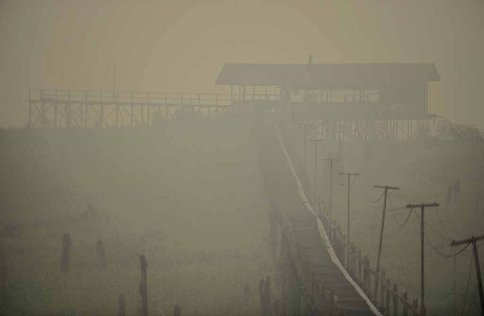 A jetty along the Kahayan River in Palangkaraya is shrouded in haze in late October. A jetty along the Kahayan River in Palangkaraya is shrouded in haze in late October.