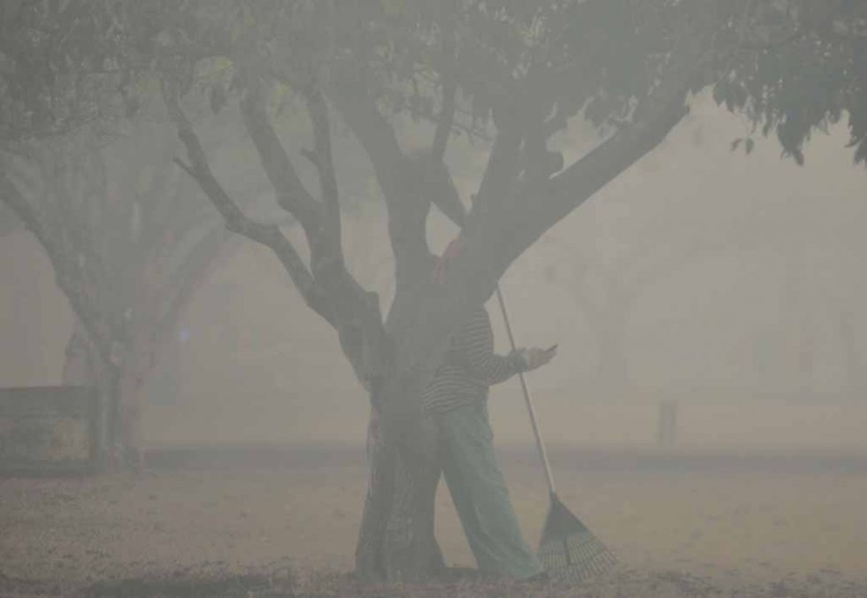 Smog surrounds a woman in downtown Palangkaraya in late October. Smog surrounds a woman in downtown Palangkaraya in late October.