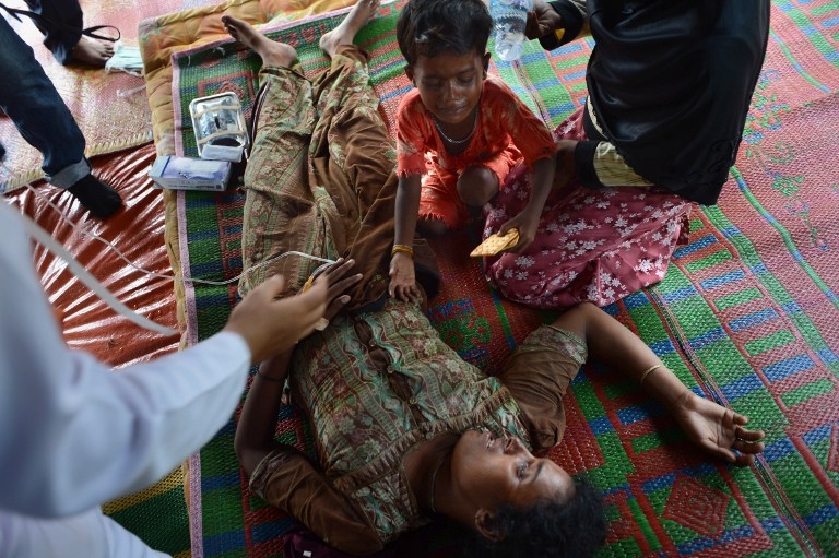Four-year-old son Abdul Hakim weeps as his mother Ambihatu, a 21-year-old Rohingya woman from Myanmar, is treated for malnutrition at a confinement area at Bayeun in Indonesia's Aceh province on May 21, 2015 Four-year-old son Abdul Hakim weeps as his mother Ambihatu, a 21-year-old Rohingya woman from Myanmar, is treated for malnutrition at a confinement area at Bayeun in Indonesia's Aceh province on May 21, 2015