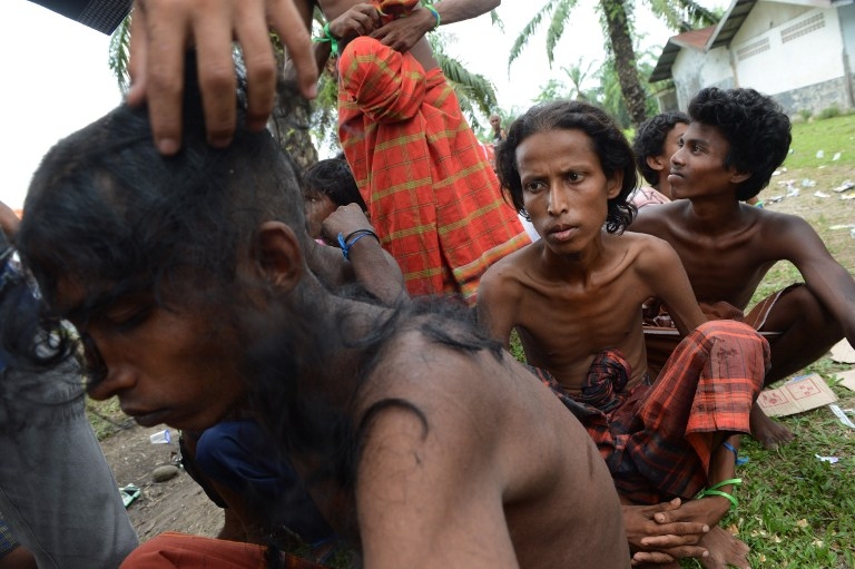 Rohingya men from Myanmar, among a group of 400 rescued off the Indonesian coast, receive haircuts at a confinement area in Bayeun, Aceh province on May 22, 2015 Rohingya men from Myanmar, among a group of 400 rescued off the Indonesian coast, receive haircuts at a confinement area in Bayeun, Aceh province on May 22, 2015