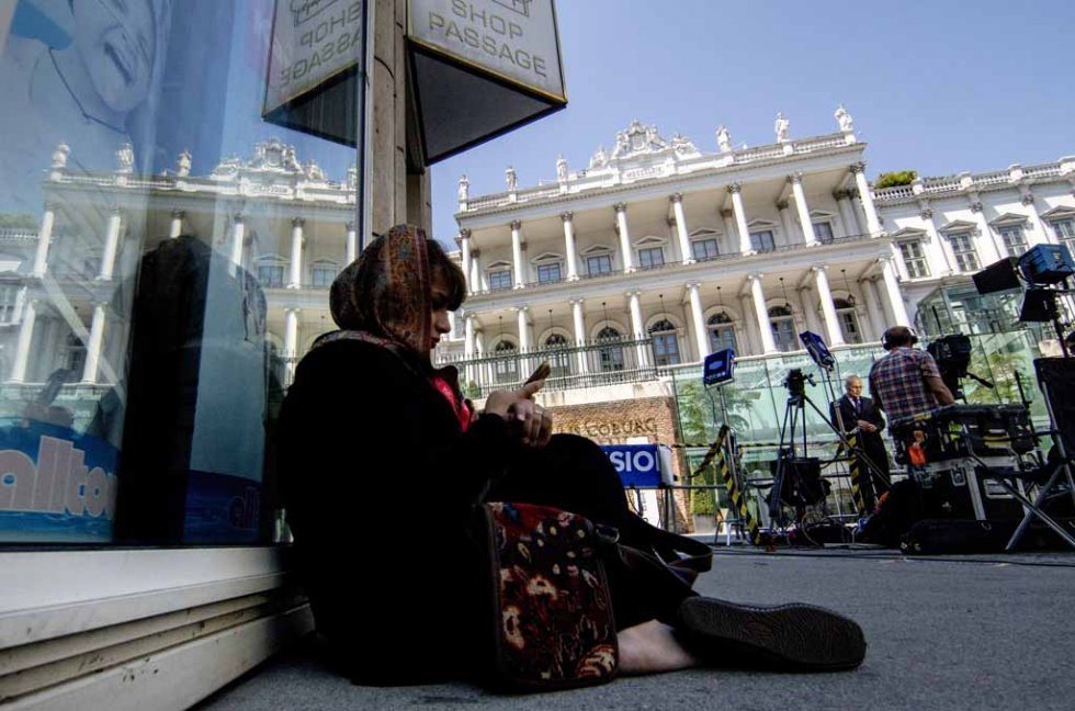 A journalist waits outside the Palais Coburg Hotel in Viennan on July 3, 2015. A journalist waits outside the Palais Coburg Hotel in Viennan on July 3, 2015.