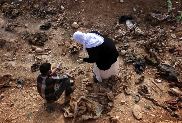 Yazidi people search for traces of their missing relatives at the site of a mass grave discovered by Kurdish forces in the Sinjar region, February 3, 2015 Yazidi people search for traces of their missing relatives at the site of a mass grave discovered by Kurdish forces in the Sinjar region, February 3, 2015