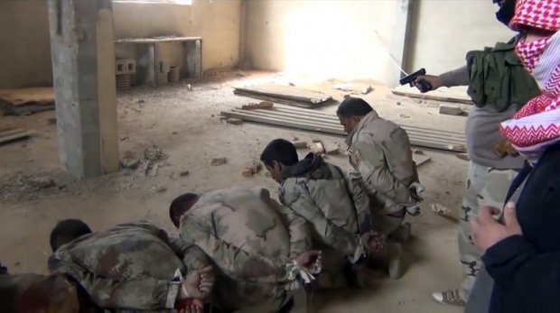 This image, pulled from a video on YouTube in February 2014, purportedly shows ISIL militants executing a group of Iraqi soldiers somewhere in Anbar province. This image, pulled from a video on YouTube in February 2014, purportedly shows ISIL militants executing a group of Iraqi soldiers somewhere in Anbar province.