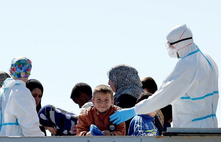 Rescued migrants arrive in the Sicilian harbour of Augusta on board the Italian Navy vessel Bettica on April 22, 2015 Rescued migrants arrive in the Sicilian harbour of Augusta on board the Italian Navy vessel Bettica on April 22, 2015