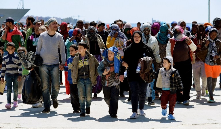 Rescued migrants on the quayside after disembarking from the Italian Navy vessel Bettica in the Sicilian harbour of Augusta on April 22, 2015 Rescued migrants on the quayside after disembarking from the Italian Navy vessel Bettica in the Sicilian harbour of Augusta on April 22, 2015