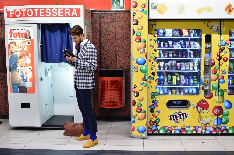 A man waits at Duomo train station during Milan Fashion Week on March 1, 2015 A man waits at Duomo train station during Milan Fashion Week on March 1, 2015