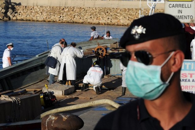 Firemen and police evacuate bodies from a boat in the port of Pozzallo, Sicily on July 1, 2014 Firemen and police evacuate bodies from a boat in the port of Pozzallo, Sicily on July 1, 2014