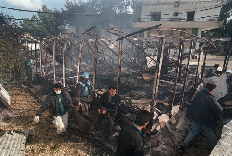 UN soldiers and civilians evacuate the bodies of victims of the shelling of Qana, on 18 April 1996 UN soldiers and civilians evacuate the bodies of victims of the shelling of Qana, on 18 April 1996