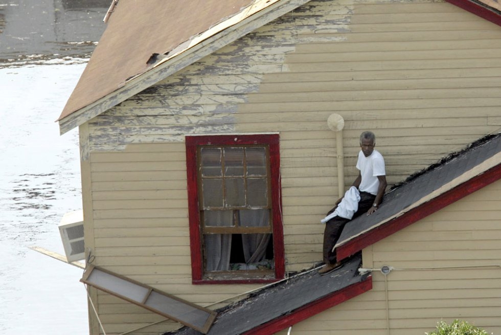 A man waits to be rescued from a roof as flood waters continue to rise on September 2, 2005 in New Orleans A man waits to be rescued from a roof as flood waters continue to rise on September 2, 2005 in New Orleans