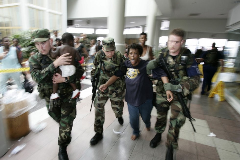 A woman in shock is helped by Louisiana National Guardsmen after gunshots were heard at New Orleans Superdome on September 1st A woman in shock is helped by Louisiana National Guardsmen after gunshots were heard at New Orleans Superdome on September 1st