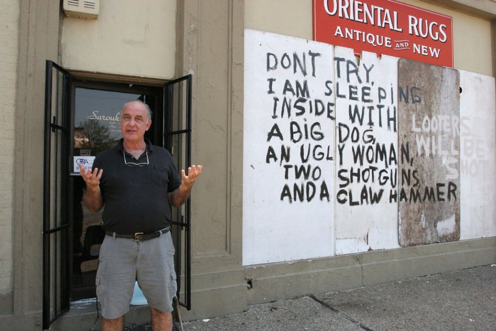 Rug store owner Bob Rue speaks in front of his shop adorned with graffiti warning looters away in New Orleans on September 4, 2005 Rug store owner Bob Rue speaks in front of his shop adorned with graffiti warning looters away in New Orleans on September 4, 2005