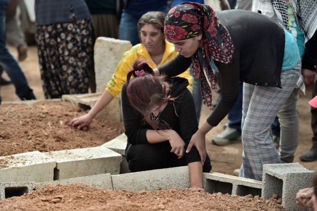 Mourners attend on October 11, 2014 in the Turkish town of Suruc, the funeral of Syrian Kurdish People's Protection Units Mourners attend on October 11, 2014 in the Turkish town of Suruc, the funeral of Syrian Kurdish People's Protection Units