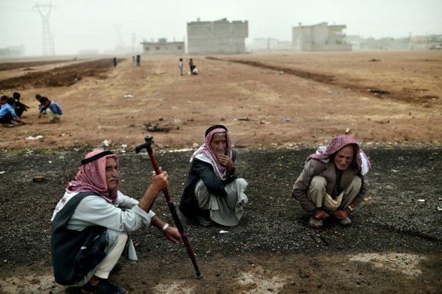 Syrian Kurdish refugees sit on October 11, 2014 outside a camp in the town of Suruc in Sanliurfa province (AFP Photo / Aris Messinis) Syrian Kurdish refugees sit on October 11, 2014 outside a camp in the town of Suruc in Sanliurfa province (AFP Photo / Aris Messinis)