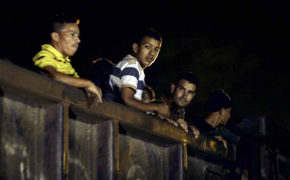 Migrants travel on board of a train in Palenque, Chiapas state, Mexico, on June 20, 2015 Migrants travel on board of a train in Palenque, Chiapas state, Mexico, on June 20, 2015