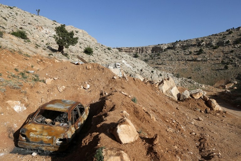 A burnt car, left behind by Al-Qaeda's Syrian affiliate Al-Nusra Front, is seen by their abandoned outpost on the Lebanese side of the Qalamun mountains on May 20, 2015 A burnt car, left behind by Al-Qaeda's Syrian affiliate Al-Nusra Front, is seen by their abandoned outpost on the Lebanese side of the Qalamun mountains on May 20, 2015