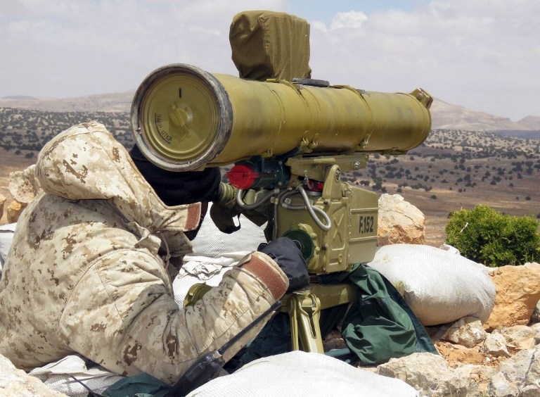 A handout picture released by the Hezbollah press office on May 13, 2015, shows a Hezbollah fighter aiming his weapon on the Syrian side of the Qalamun hills close to the Lebanese border A handout picture released by the Hezbollah press office on May 13, 2015, shows a Hezbollah fighter aiming his weapon on the Syrian side of the Qalamun hills close to the Lebanese border
