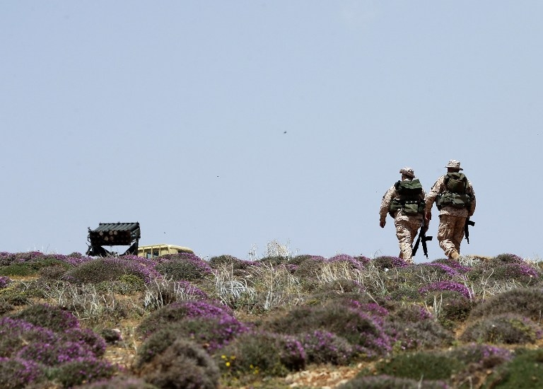 Two Hezbollah fighters patrol a hill on the Lebanese side of the Qalamun mountains on May 20, 2015 Two Hezbollah fighters patrol a hill on the Lebanese side of the Qalamun mountains on May 20, 2015