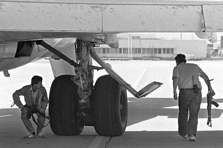 Two hijackers inspect the underside of the TWA Boeing in Beirut on June 19, 1985 Two hijackers inspect the underside of the TWA Boeing in Beirut on June 19, 1985