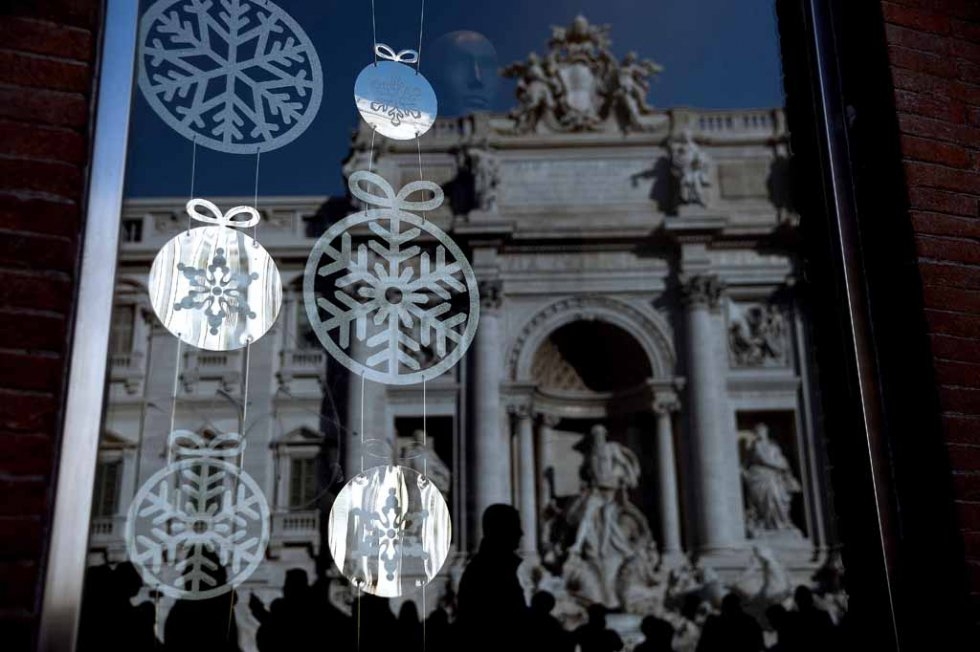 Trevi Fountain reflected in a window shop. December, 2015. Trevi Fountain reflected in a window shop. December, 2015.