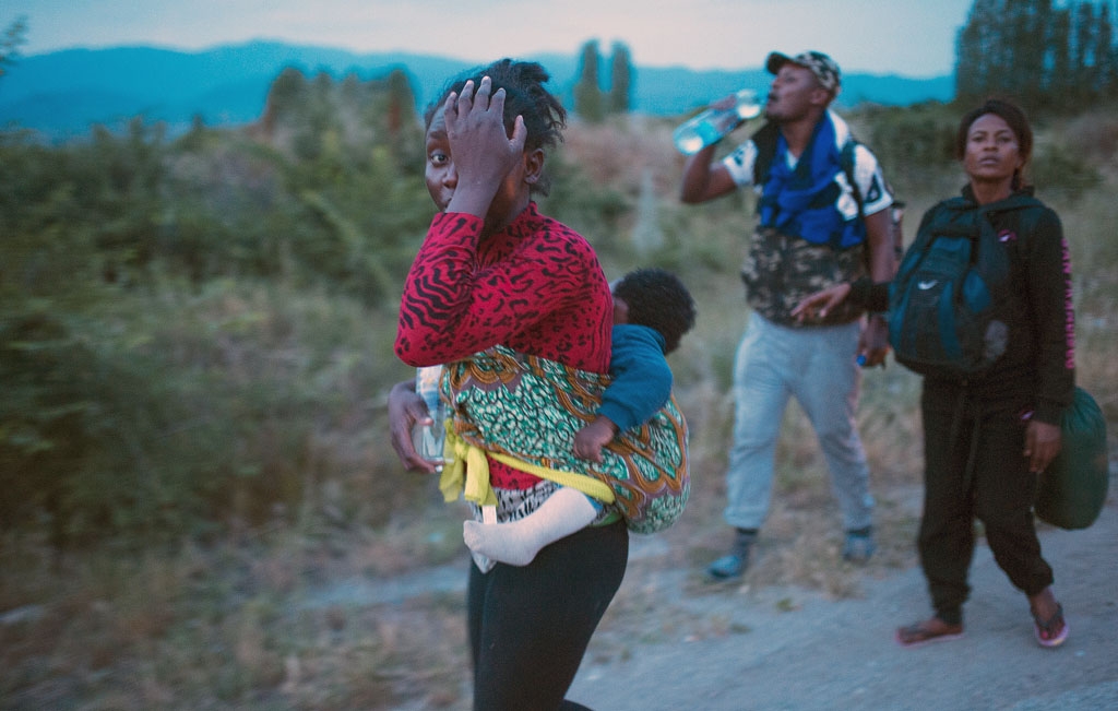 Migrants walk near Demir Kapija, on the way to the Serbian border on June 10, 2015 Migrants walk near Demir Kapija, on the way to the Serbian border on June 10, 2015