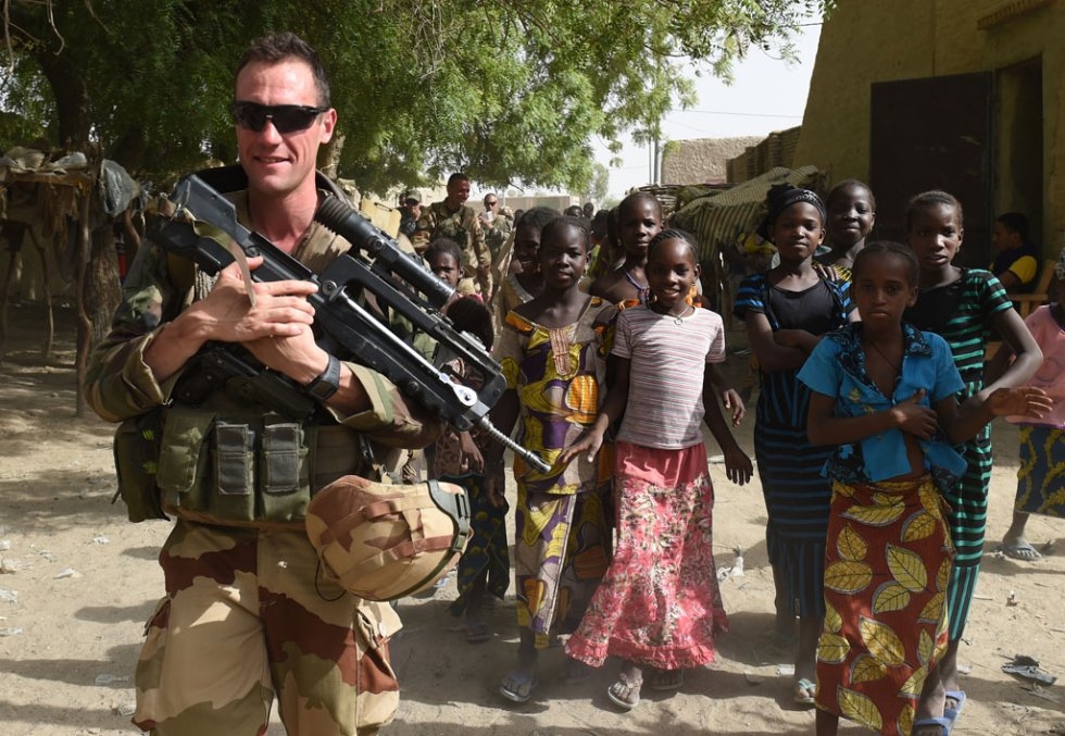 Youngsters gather beside French and Malian troops at Douekire in the Timbuktu region on June 2, 2015 Youngsters gather beside French and Malian troops at Douekire in the Timbuktu region on June 2, 2015