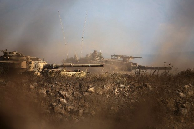 An Israeli soldier sits in his Merkava tank on alert position on the Israeli-annexed Golan Heights near the Quneitra crossing with Syria, on September 1, 2014 An Israeli soldier sits in his Merkava tank on alert position on the Israeli-annexed Golan Heights near the Quneitra crossing with Syria, on September 1, 2014