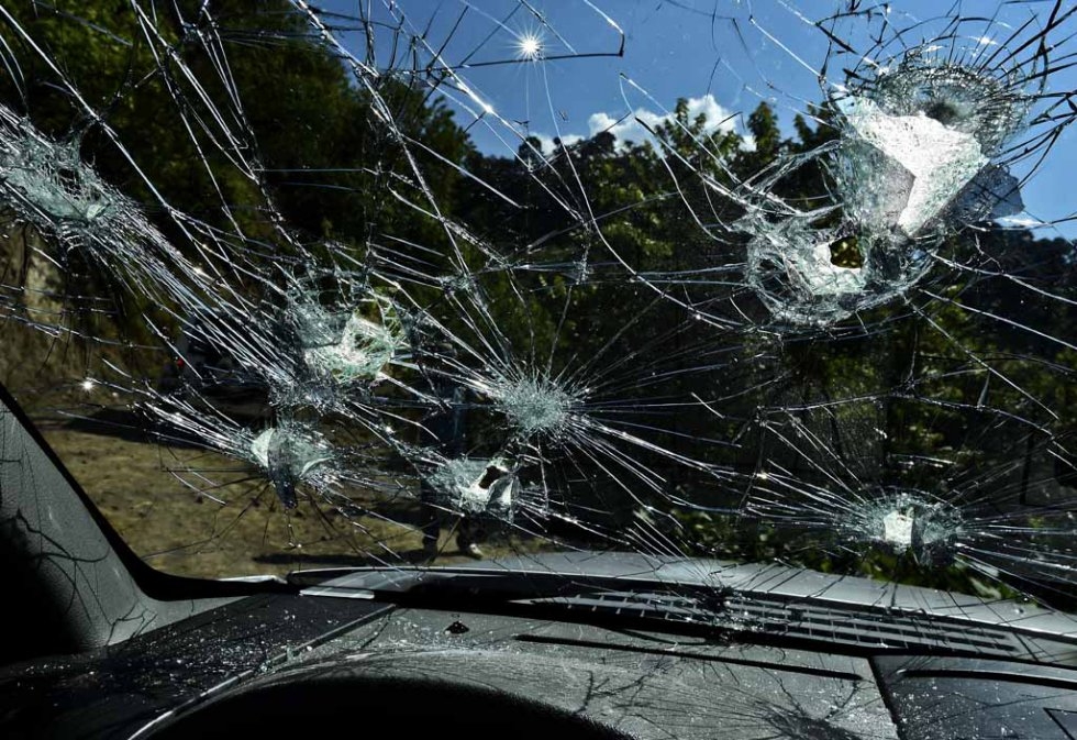 Bullet holes riddle the front shield of a truck at the El Aguila ranch. Bullet holes riddle the front shield of a truck at the El Aguila ranch.