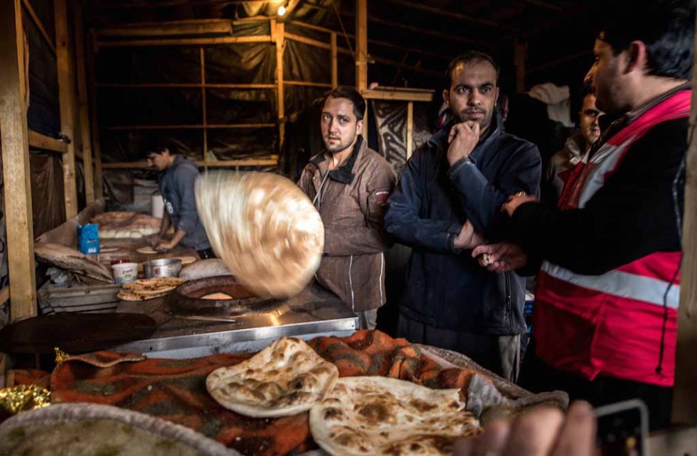 Cooking bread in a makeshift restaurant in the Jungle. January, 2016. Cooking bread in a makeshift restaurant in the Jungle. January, 2016.